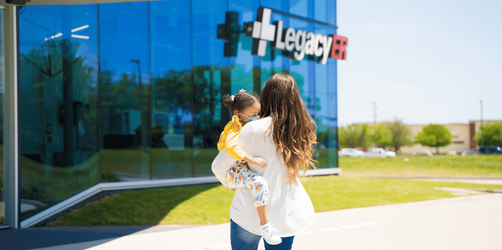 mother and daughter walking into healthcare facility