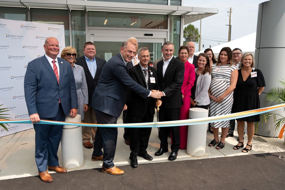 A group of officials cut the ribbon in a ceremony for a new facility
