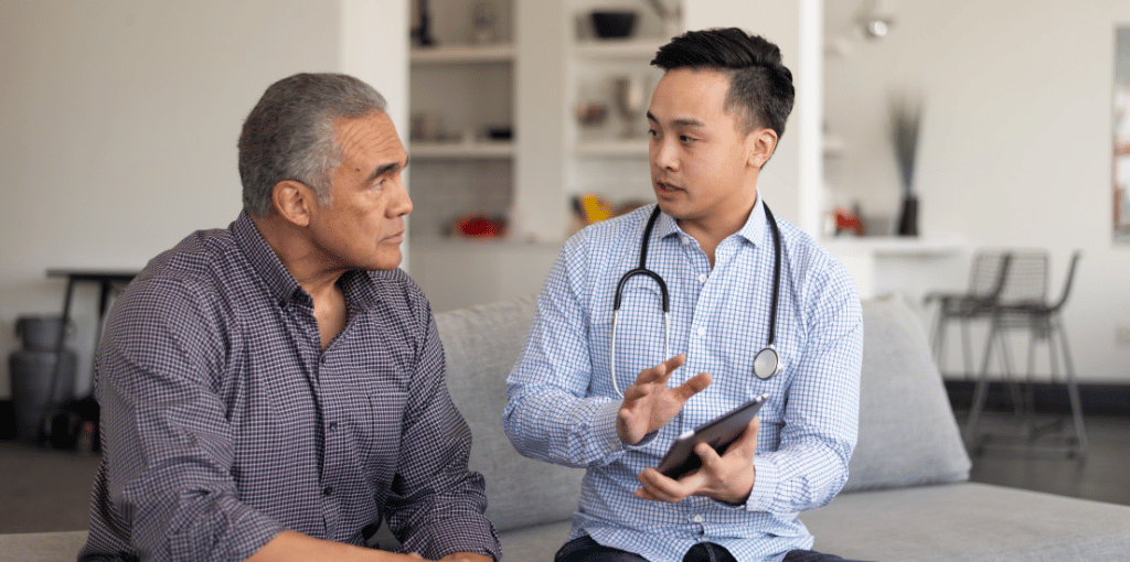 doctor talking to patient with tablet in his hand