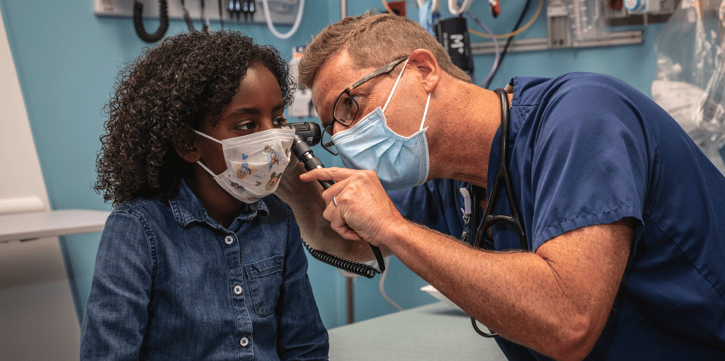 provider looking into a child patient's ear