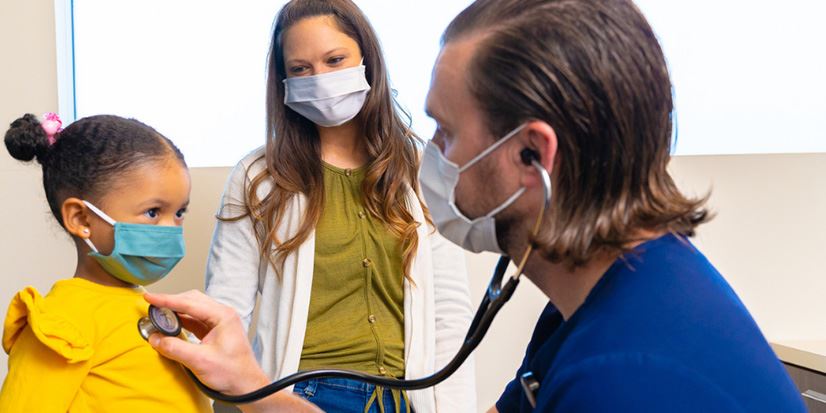 provider with a stethoscope and a child